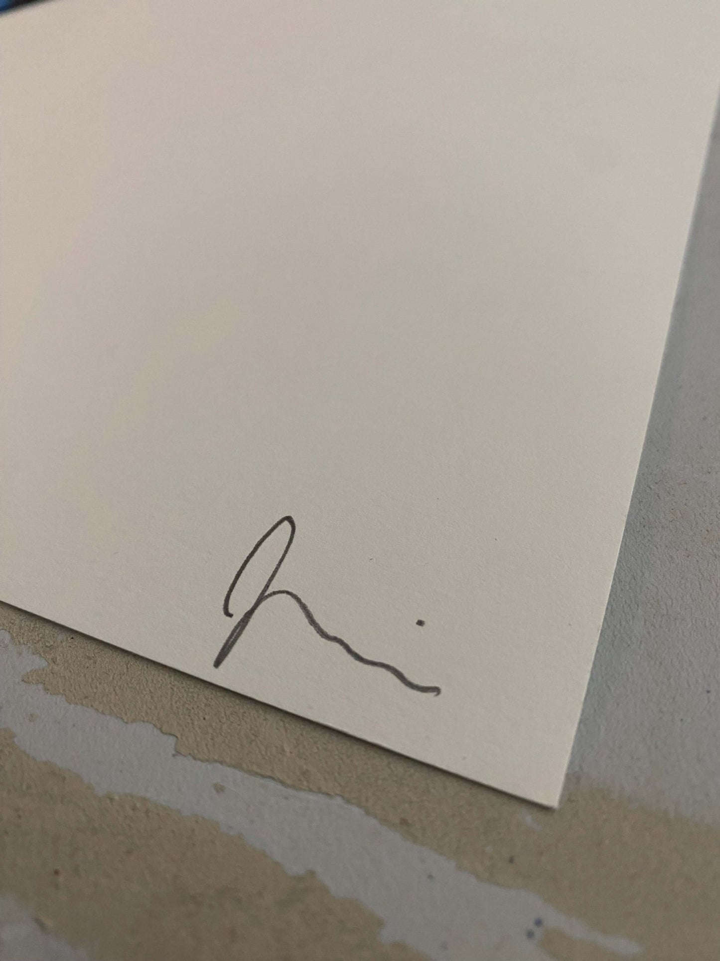 Signature on off-white paper, detail of a limited edition serigraph art print.